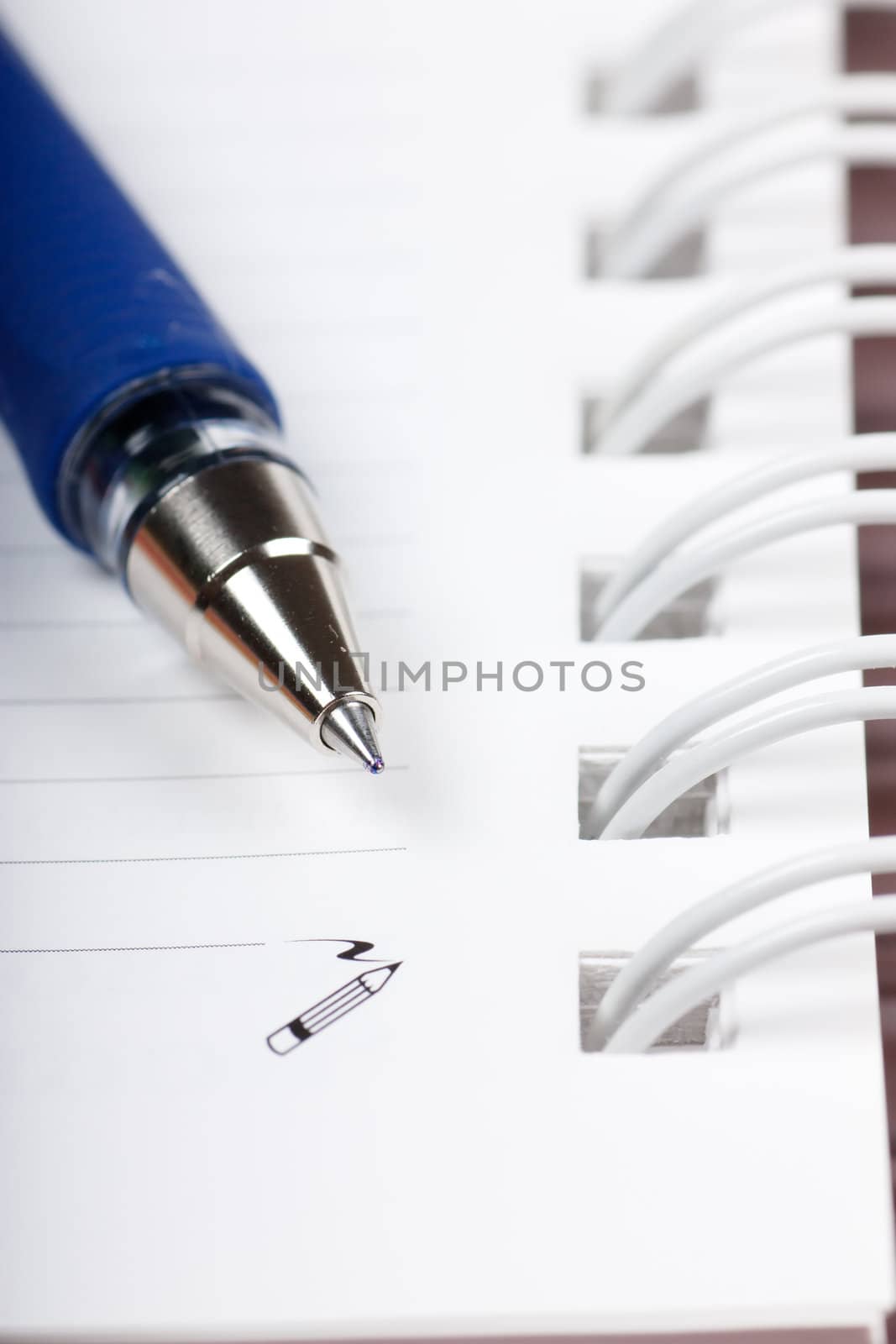 Macro view of blank spiral notebook and ball pen