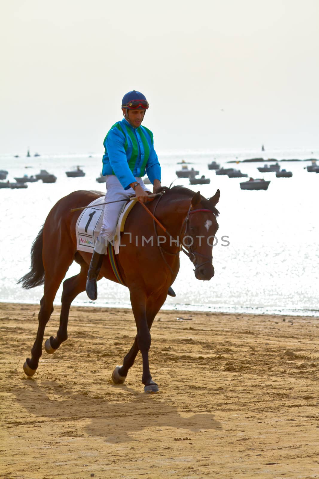 SANLUCAR DE BARRAMEDA, CADIZ, SPAIN - AUGUST 11: Unidentified rider at the start of race horses on Sanlucar de Barrameda beach on August 11, 2011 in Sanlucar de Barrameda, Cadiz, Spain.