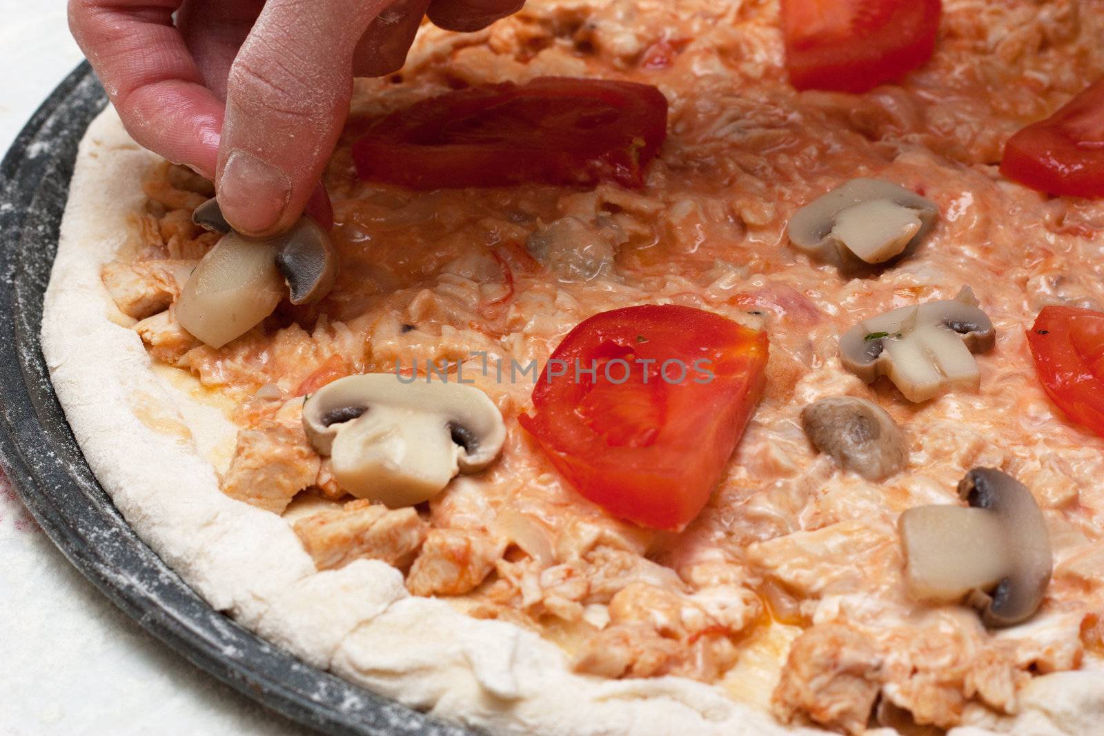 Preparation of vegetarian pizza.