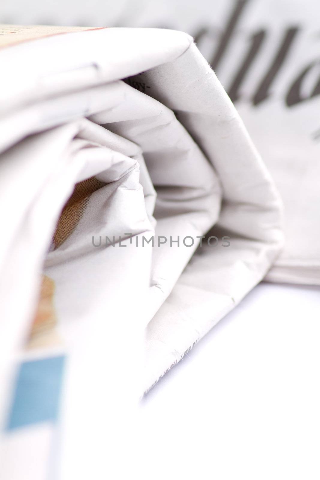 Closeup of folded newspaper isolated on white background.