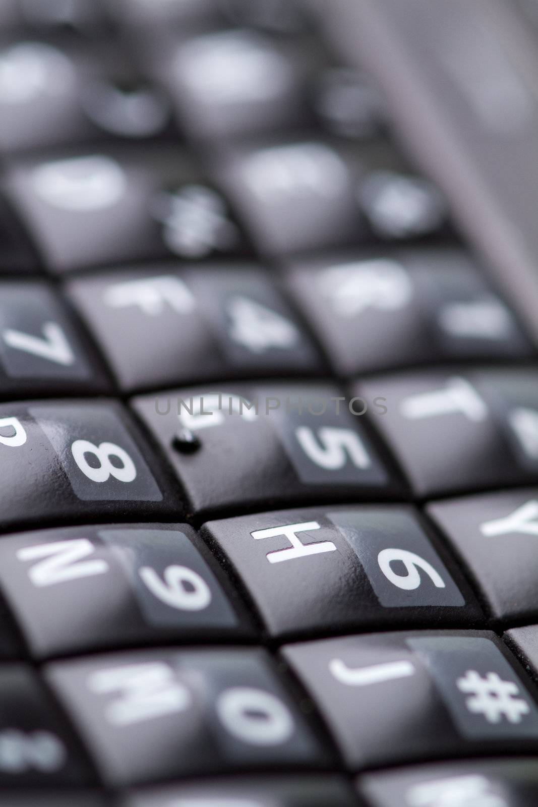 qwerty keypad from a smartphone shot with a narrow depth of field.