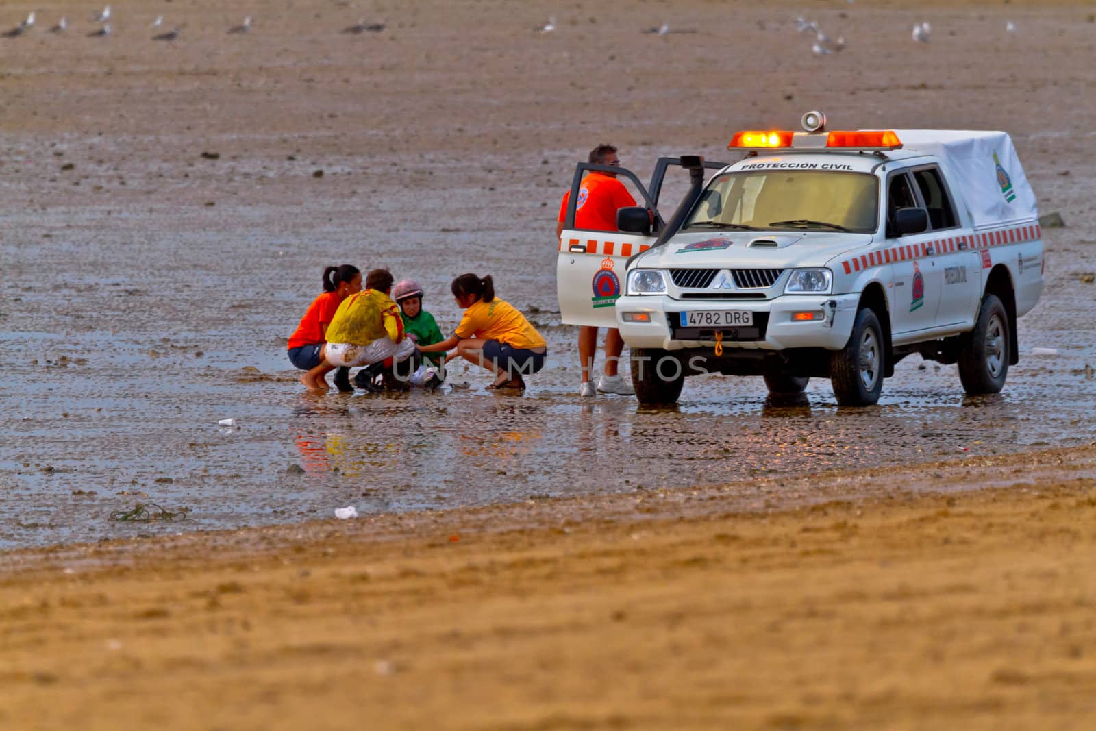 SANLUCAR DE BARRAMEDA, CADIZ, SPAIN - AUGUST 11: Accidented jockey stays in the ground  on horses races of the beach of Sanlucar de Barrameda on August 11, 2011 in Sanlucar de Barrameda, Cadiz, Spain.