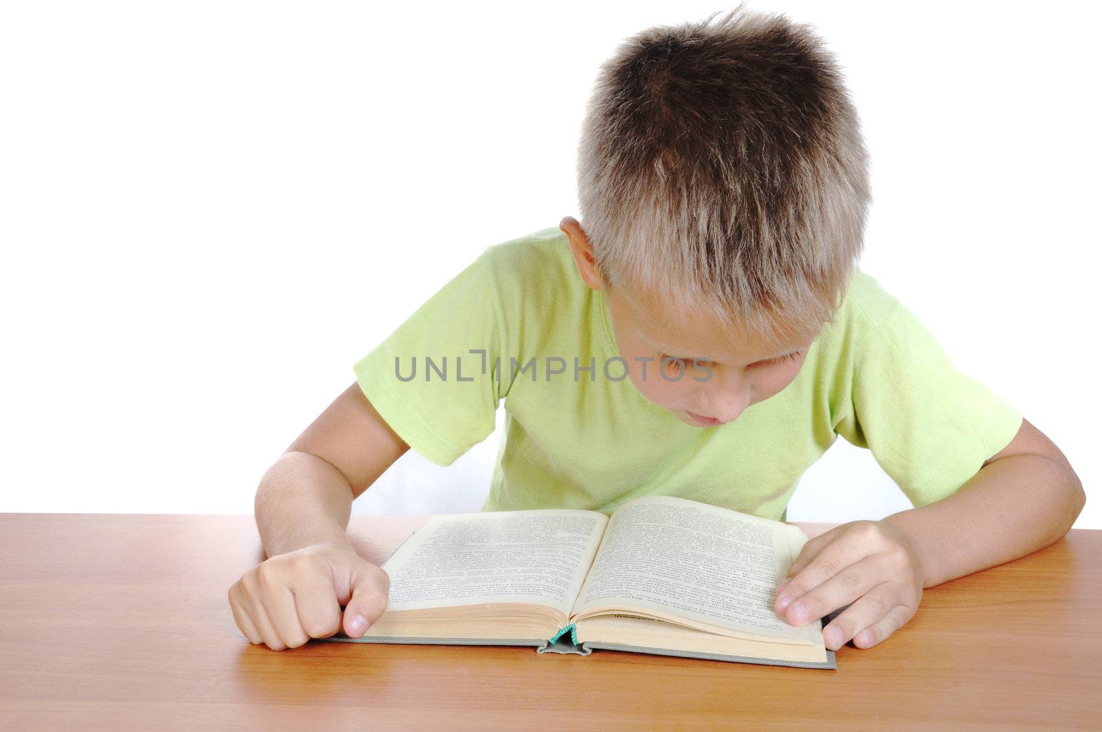 boy reads book on table on white background