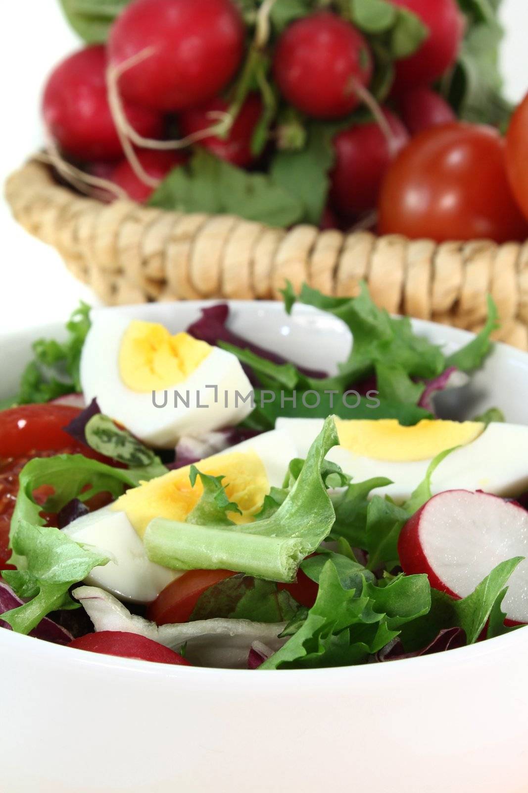 a white bowl of fresh mixed salad