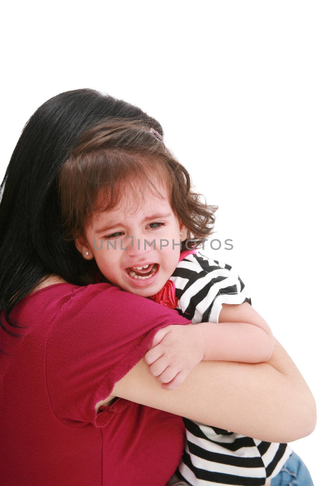 Little girl crying in mothers arm, isolated on white by dacasdo