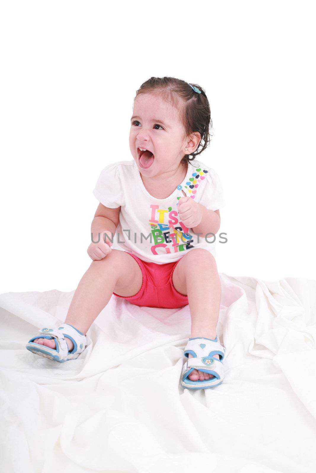 Portrait of emotionally kid. Funny little girl isolated on white background. Beautiful caucasian model.