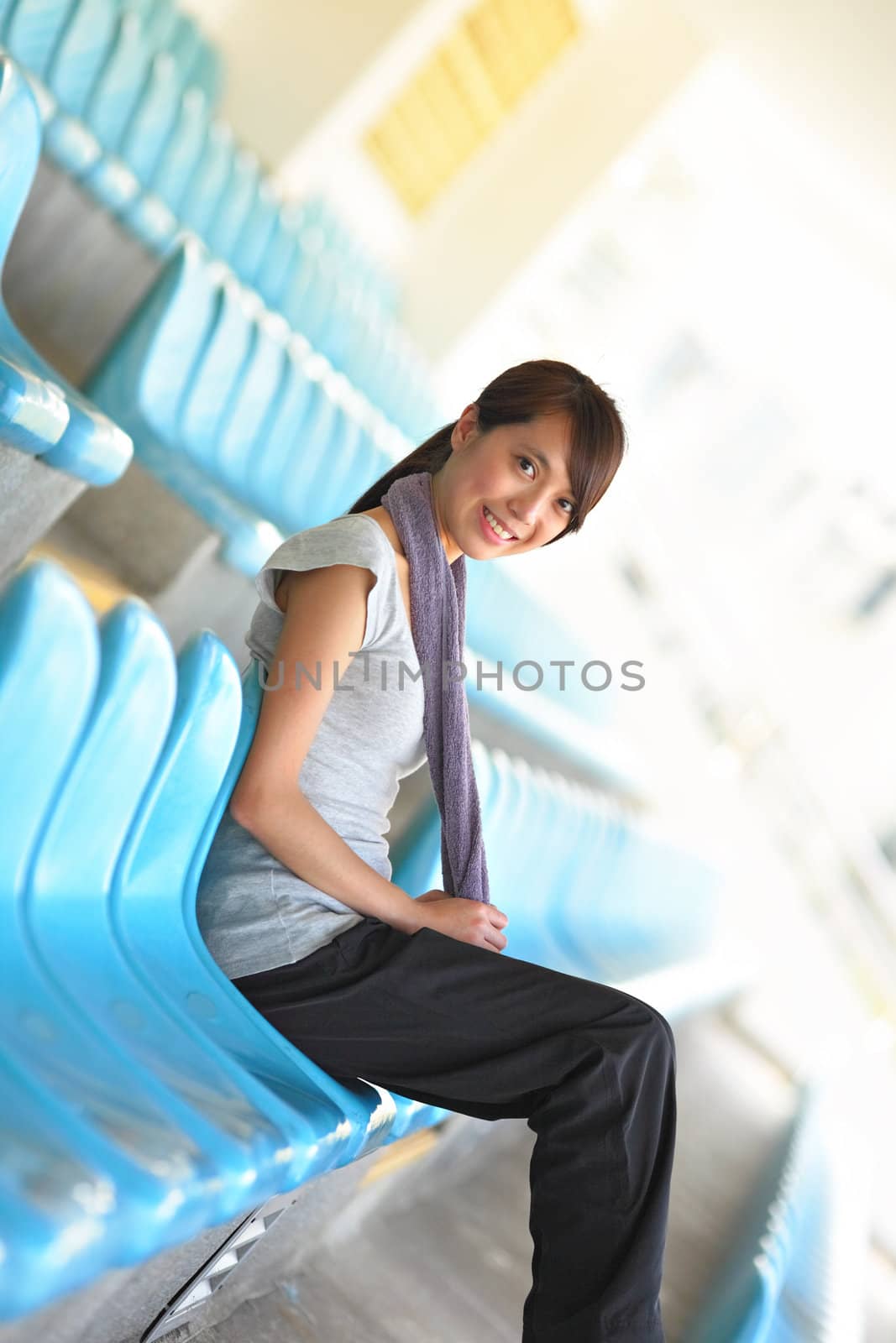 sporty girl sit in sport arena
