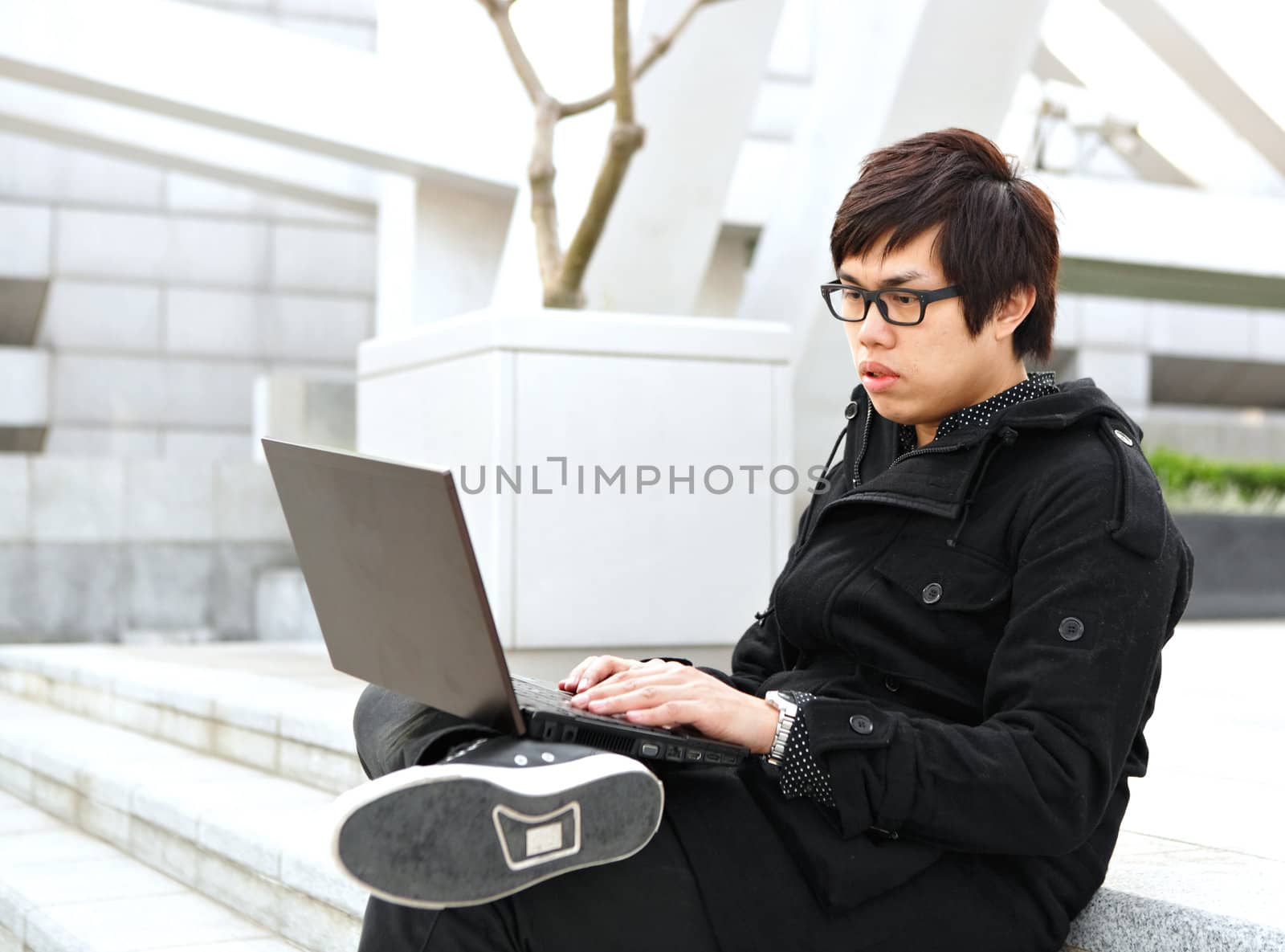 man using computer outdoor