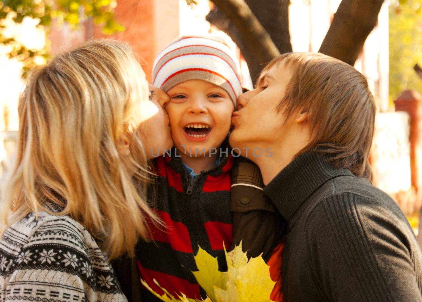 Happy family of three at fall time by AndreyKr