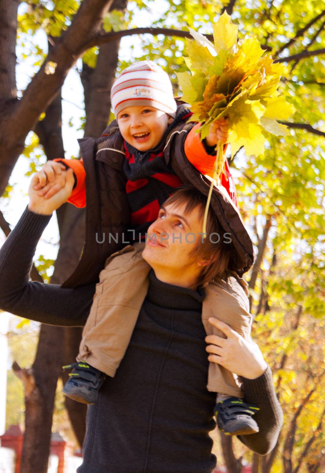 Happy father and son at fall time by AndreyKr