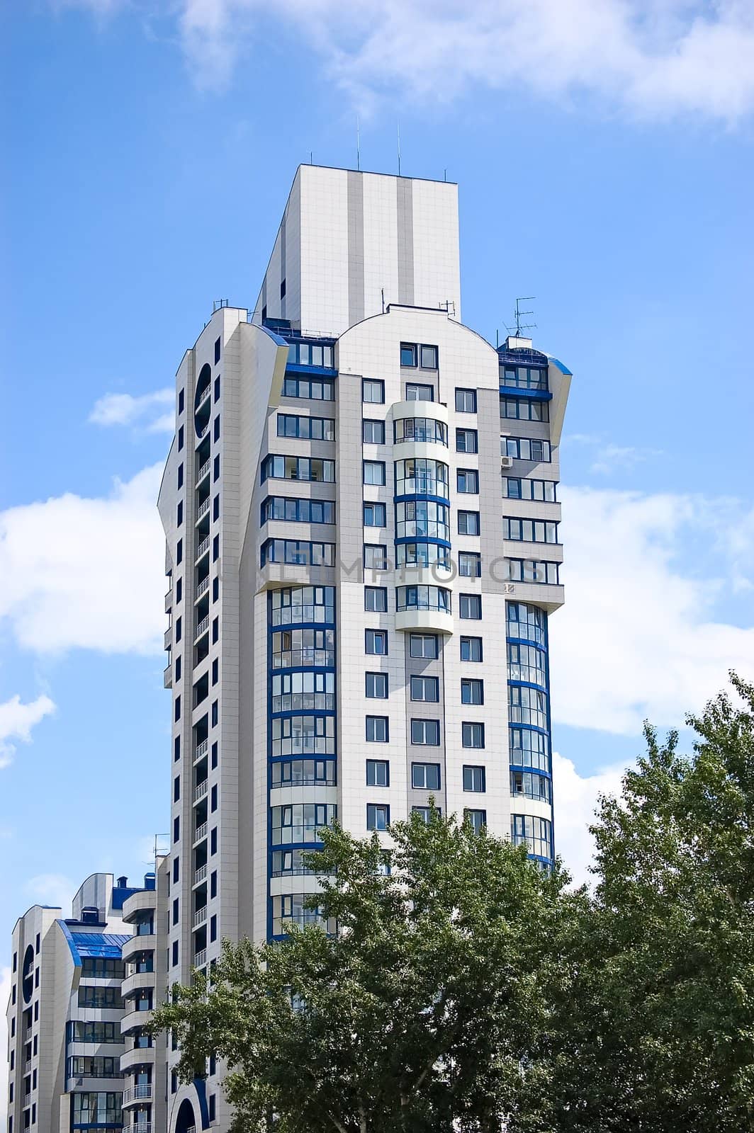 Modern office building on blue sky background