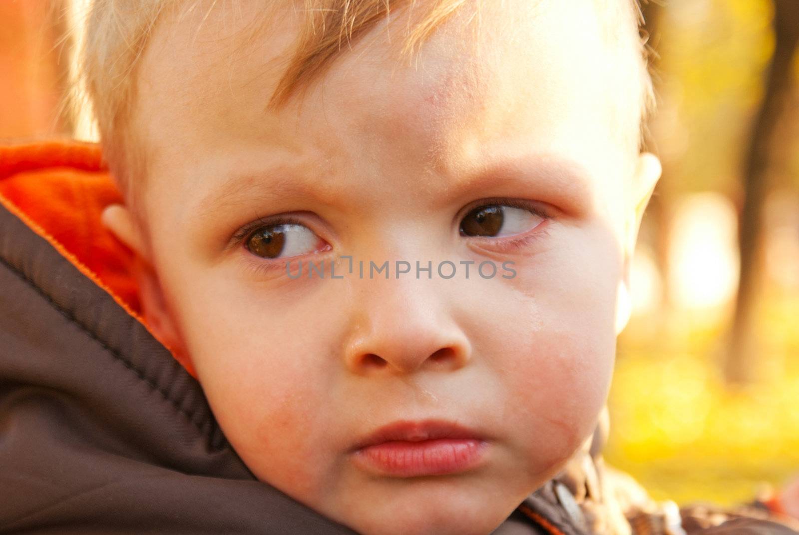 Little boy crying outdoors by AndreyKr