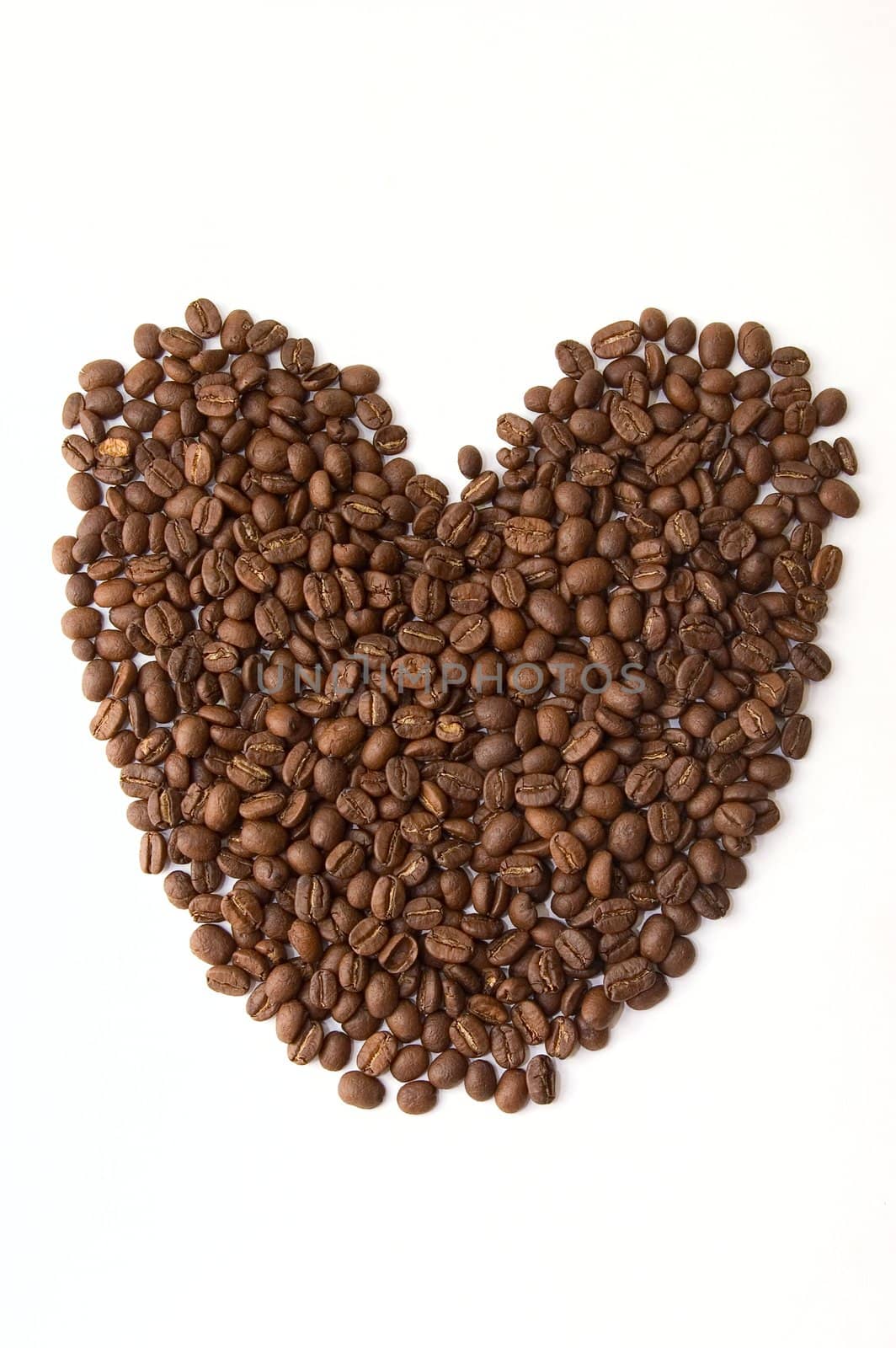 Coffee beans as heart on white background