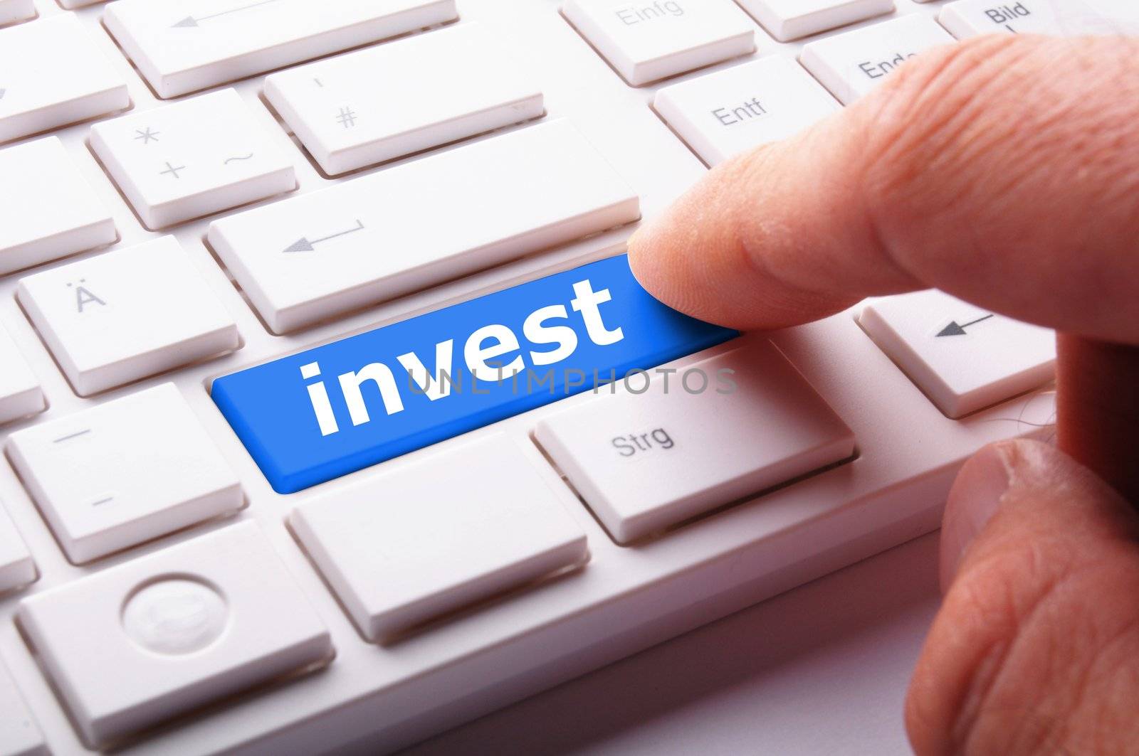 invest key on keyboard showing financial business investment concept