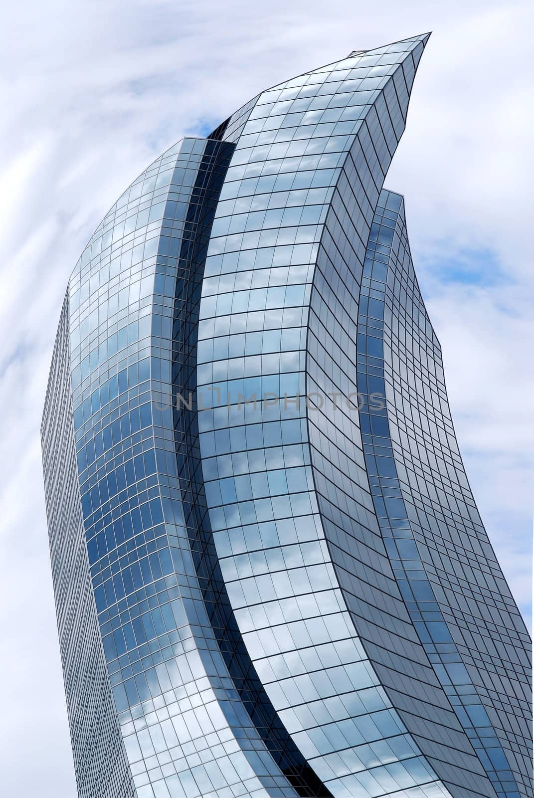Distorted futuristic corporate building with glass walls reflecting clouds