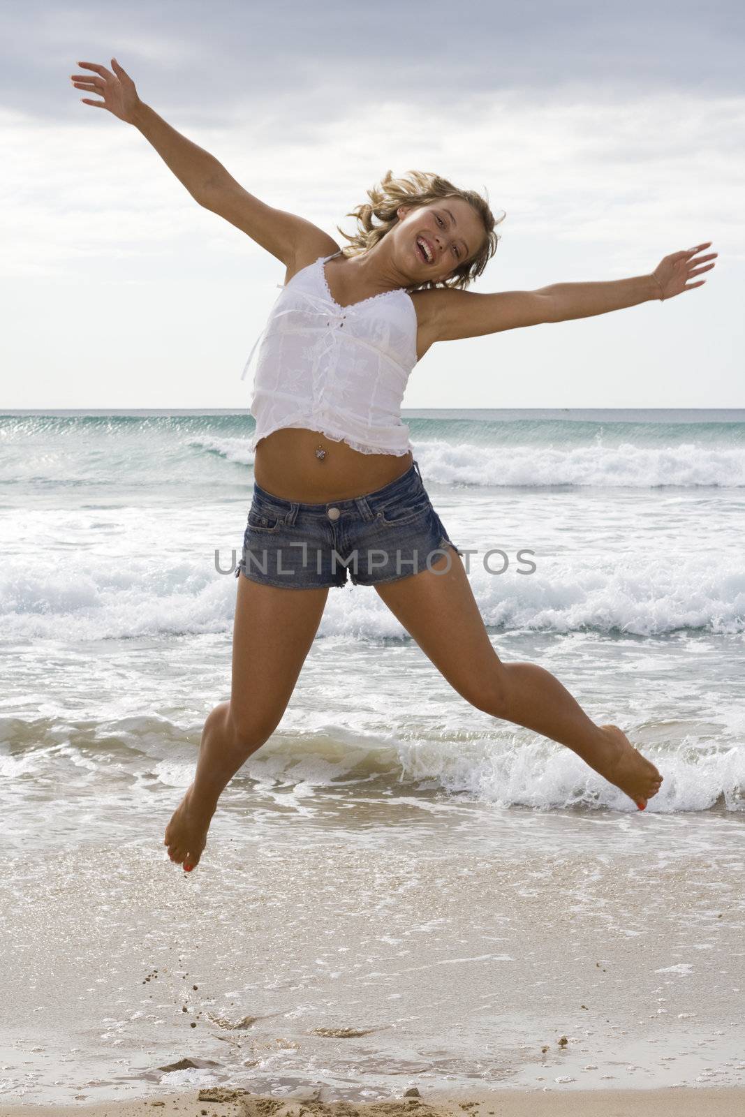 Girl jumping in the air with arms spread