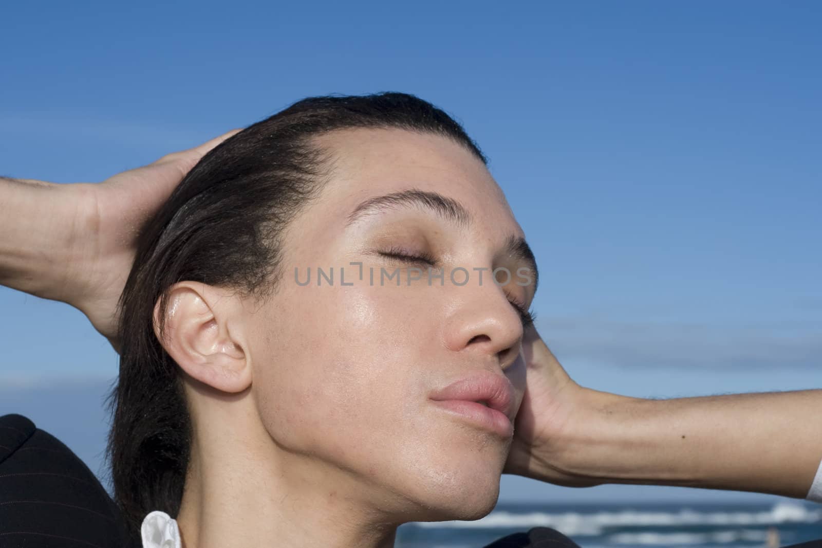 Young business professional holding his hands to his head