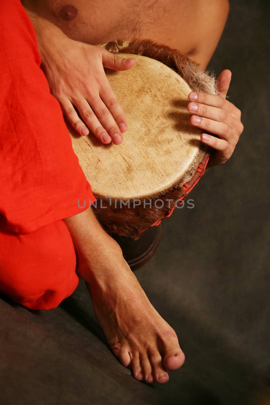 Man playing the nigerian drum in studio