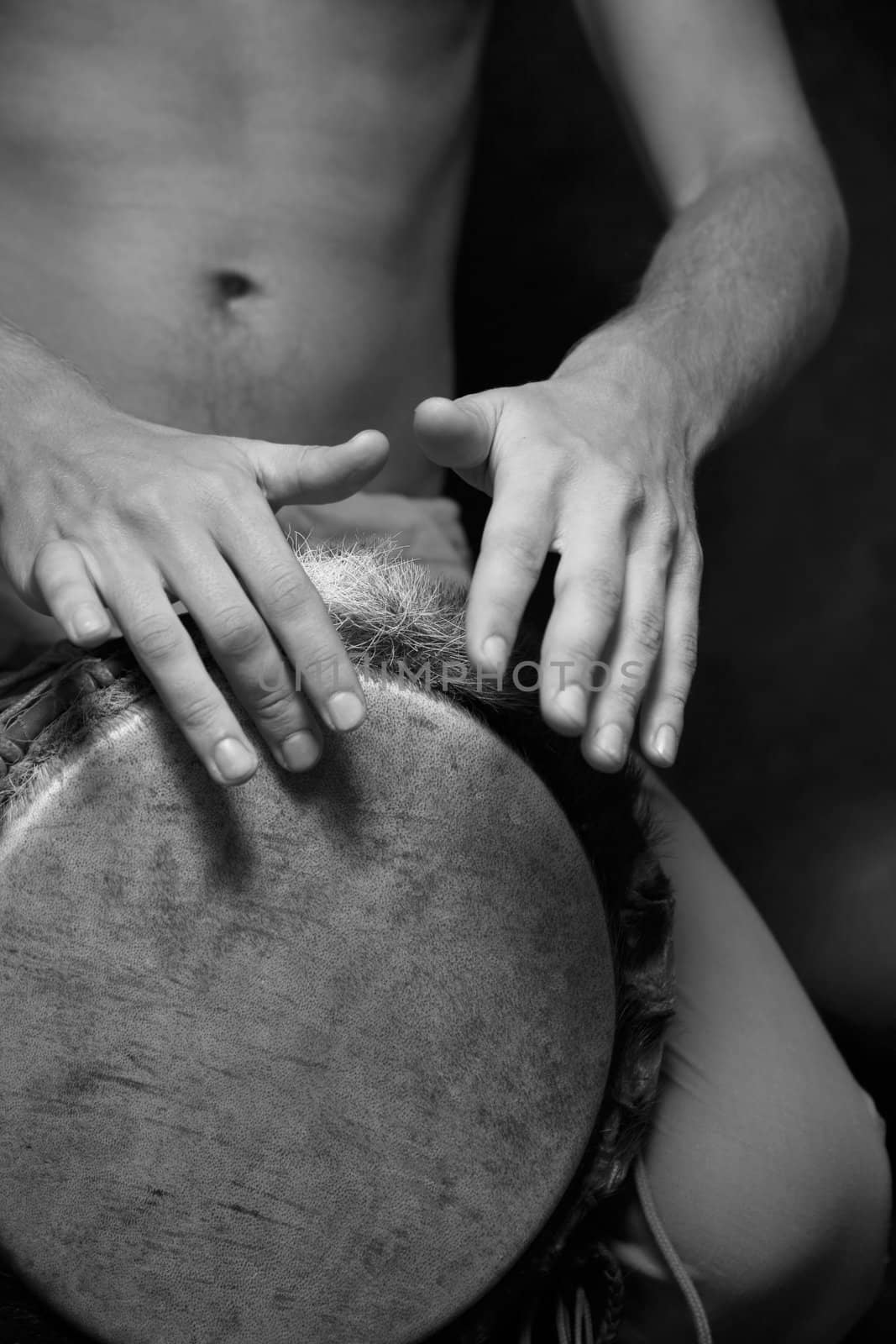 Man playing the djembe (nigerian drum) in studio