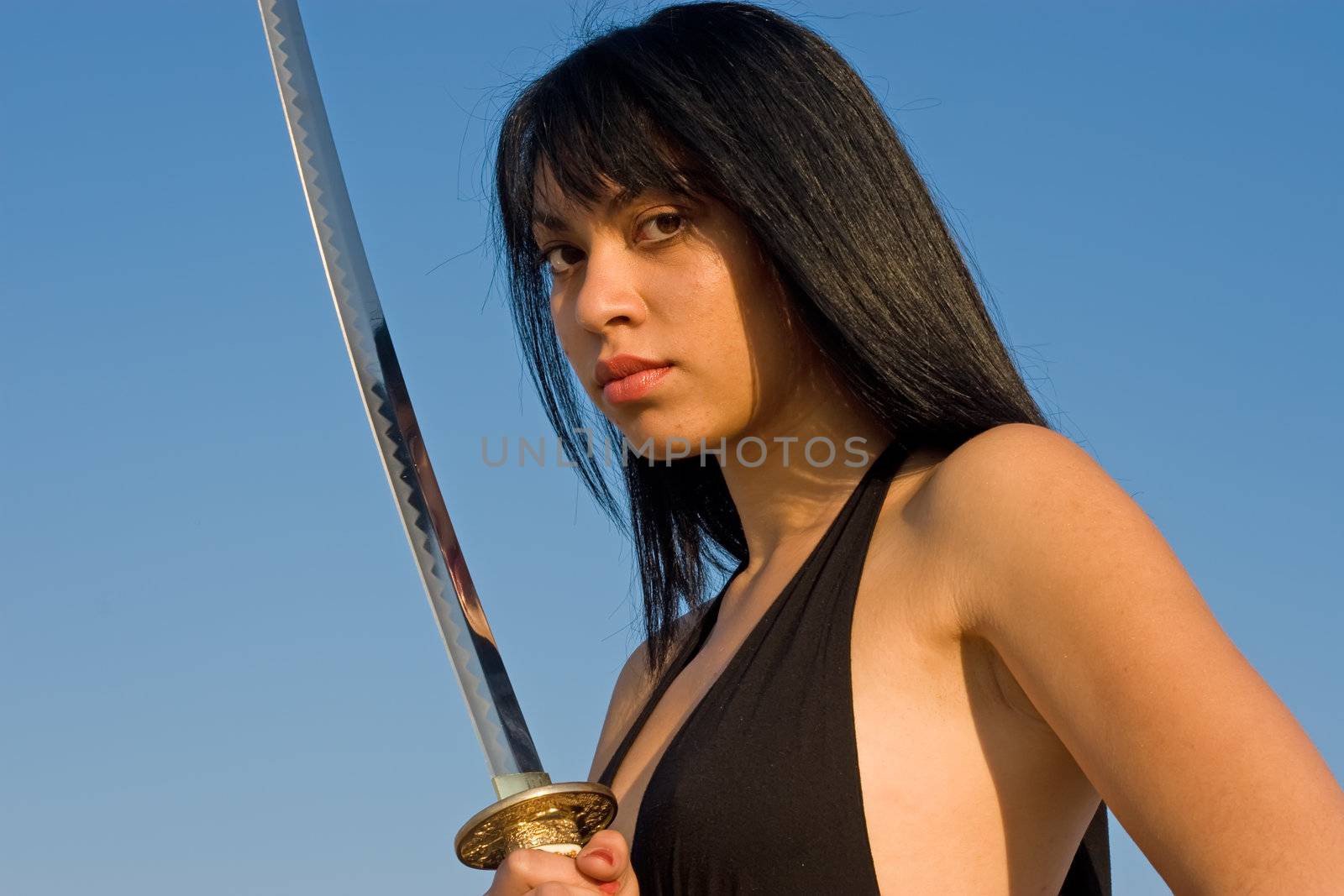 Attractive female holding a sword with reflection
