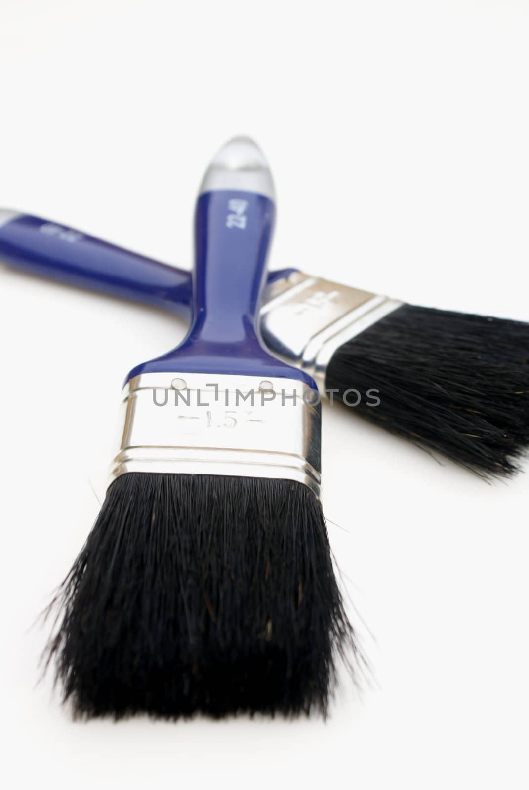 Two paintbrushes against a white background.            