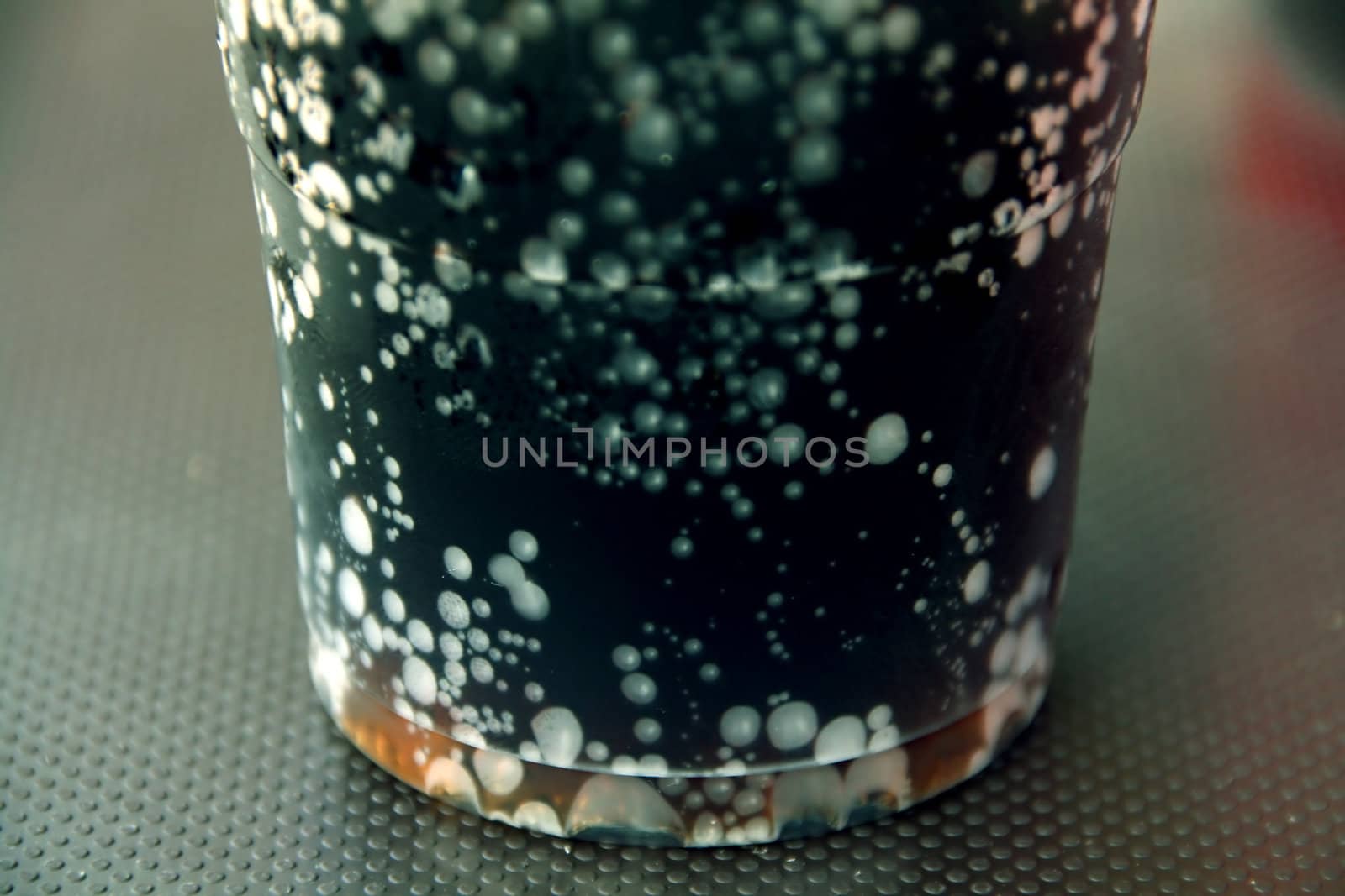 macro of a refreshing glass of drink at a summer day on a table.