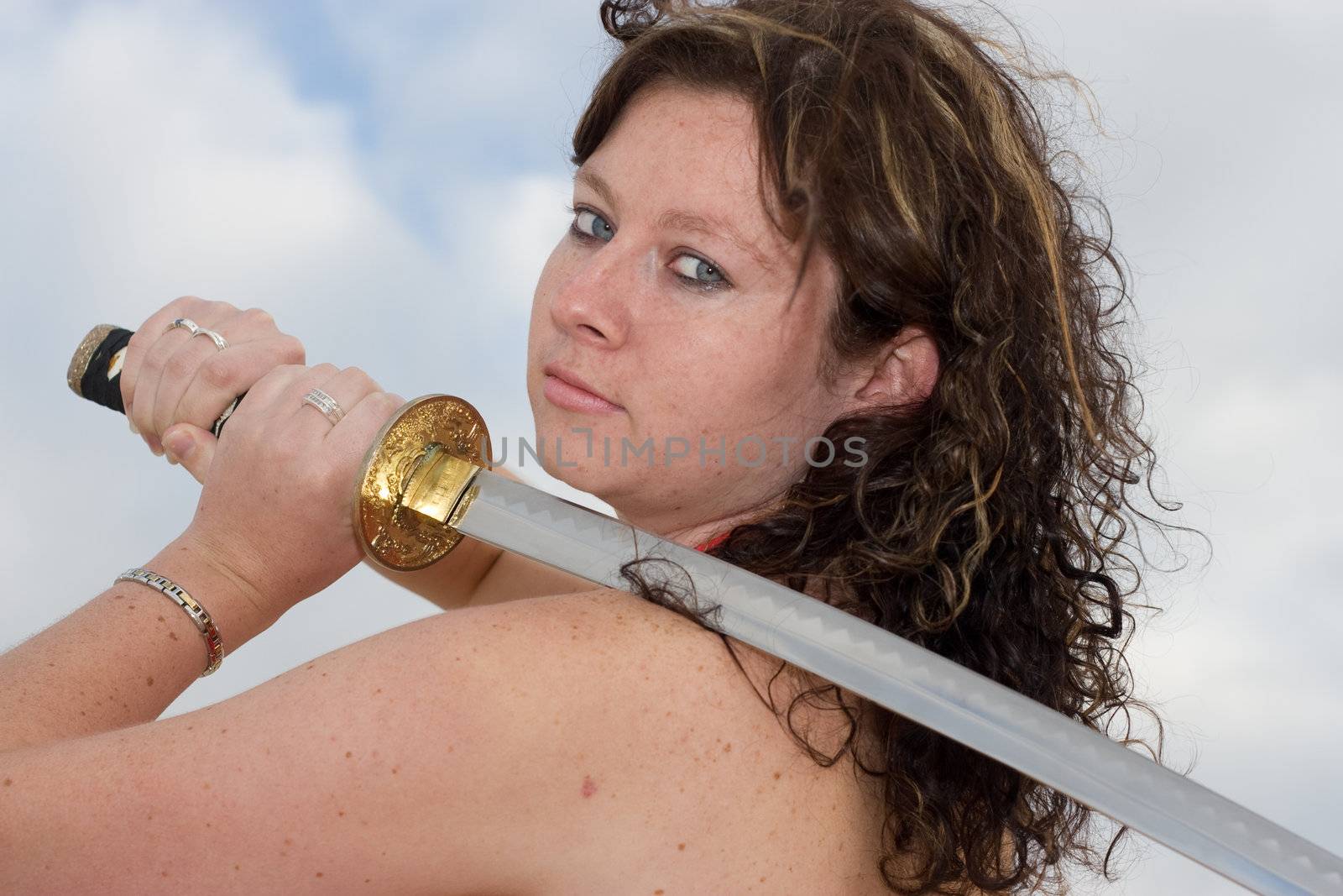 Close up of an attractive model posing with a sword