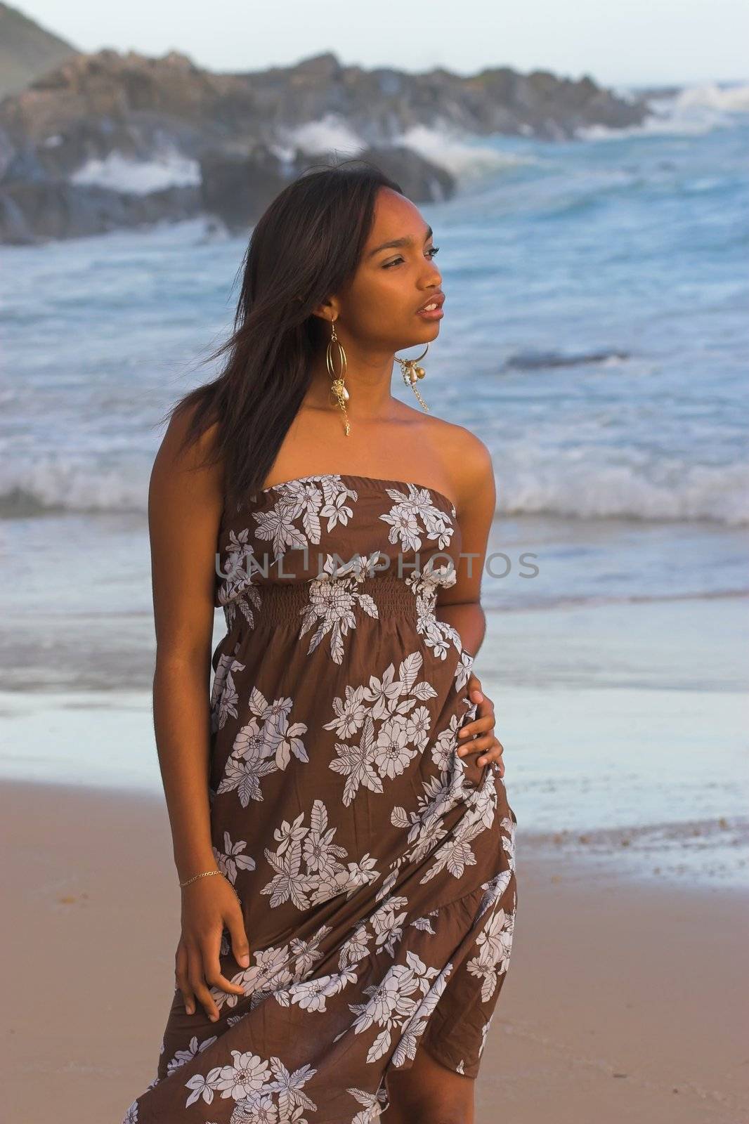 Ethnic girl in brown floral print at the beach