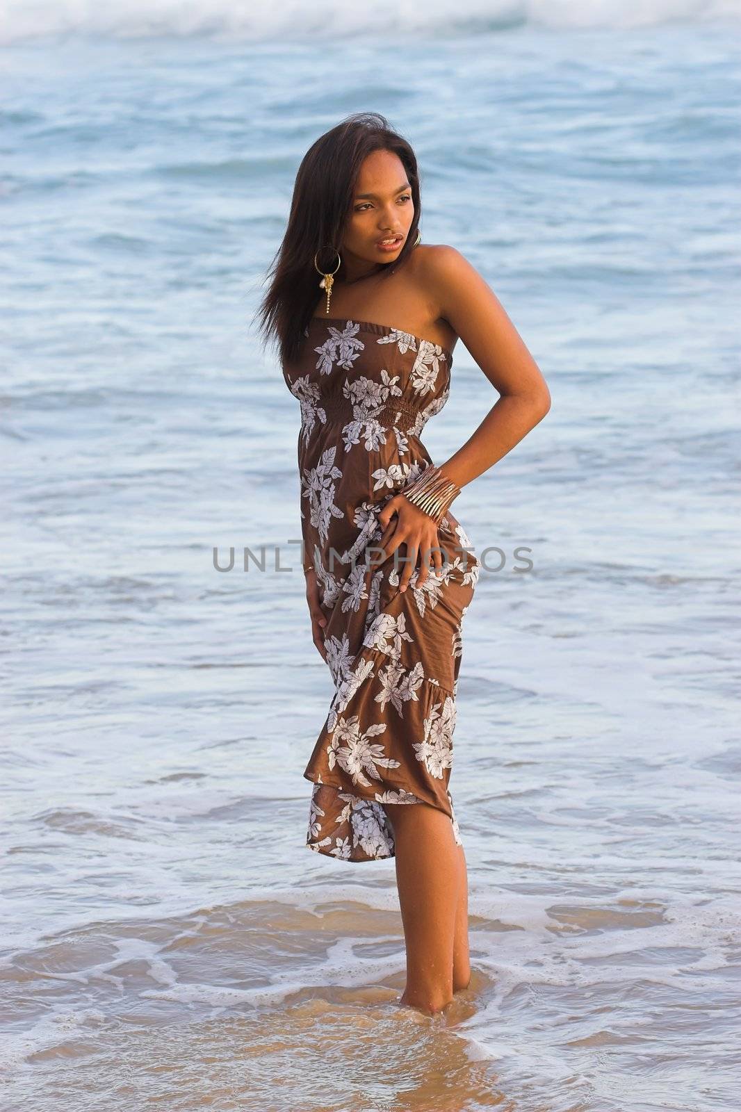 Caribbean model standing in the water at the beach