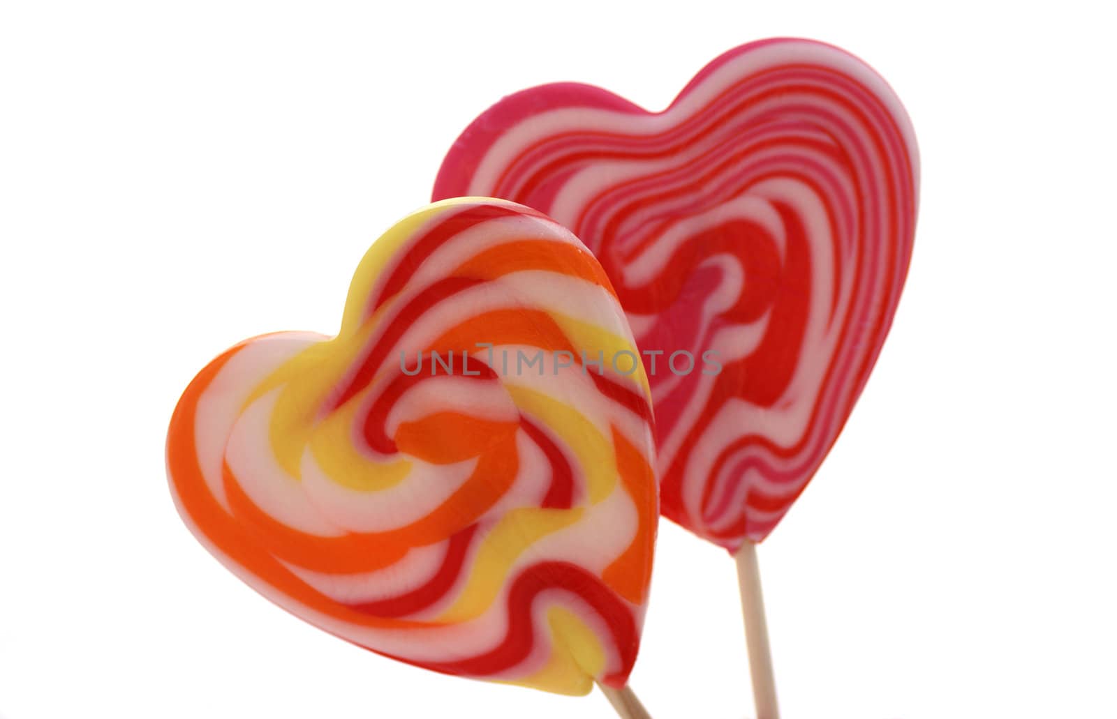 Two isolated heart shaped lollypops.
