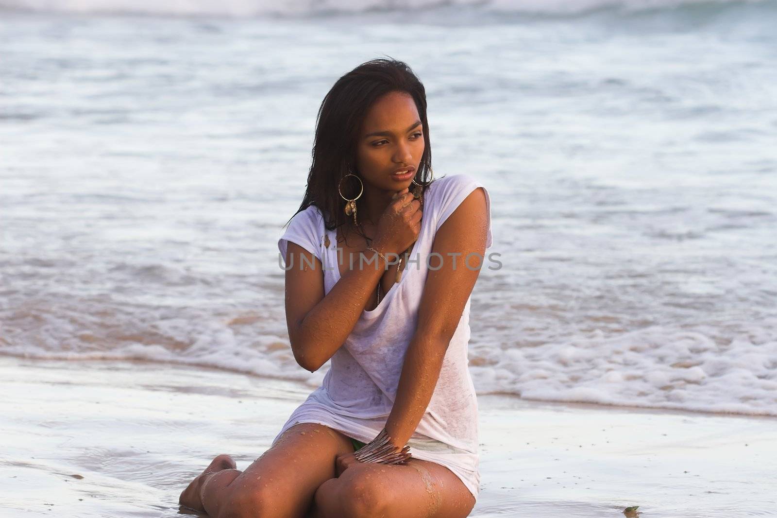 Caribbean model in wet t-shirt at the beach