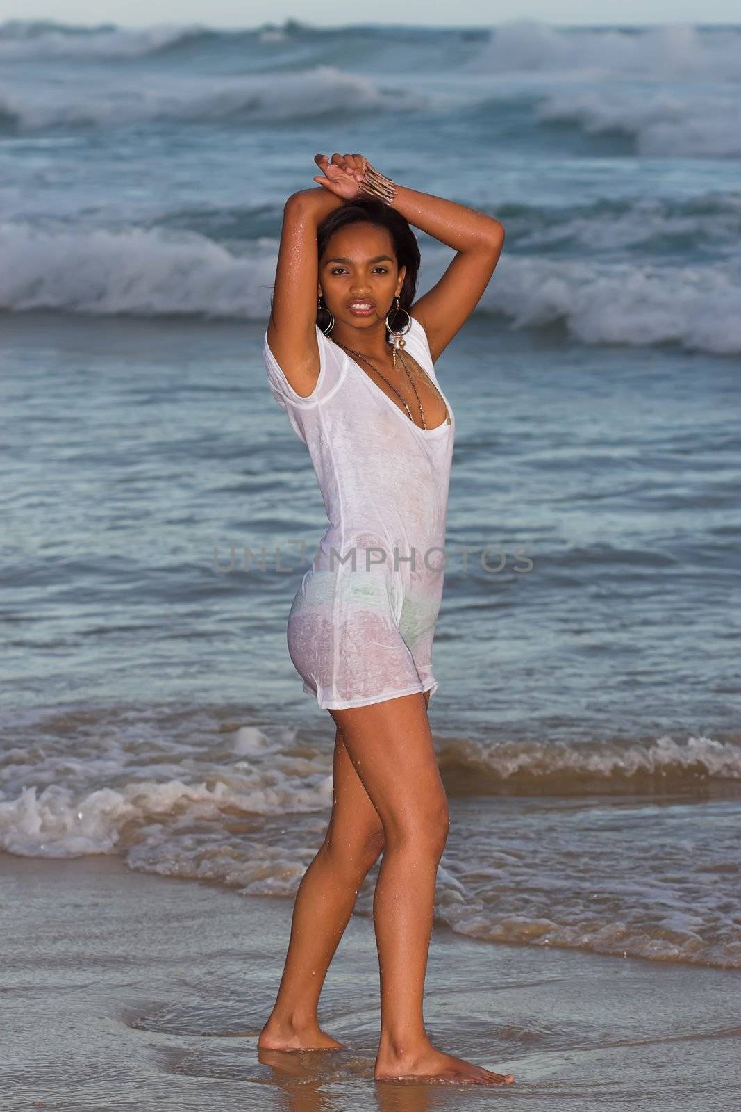Ethnic Girl in wet t-shirt at the beach