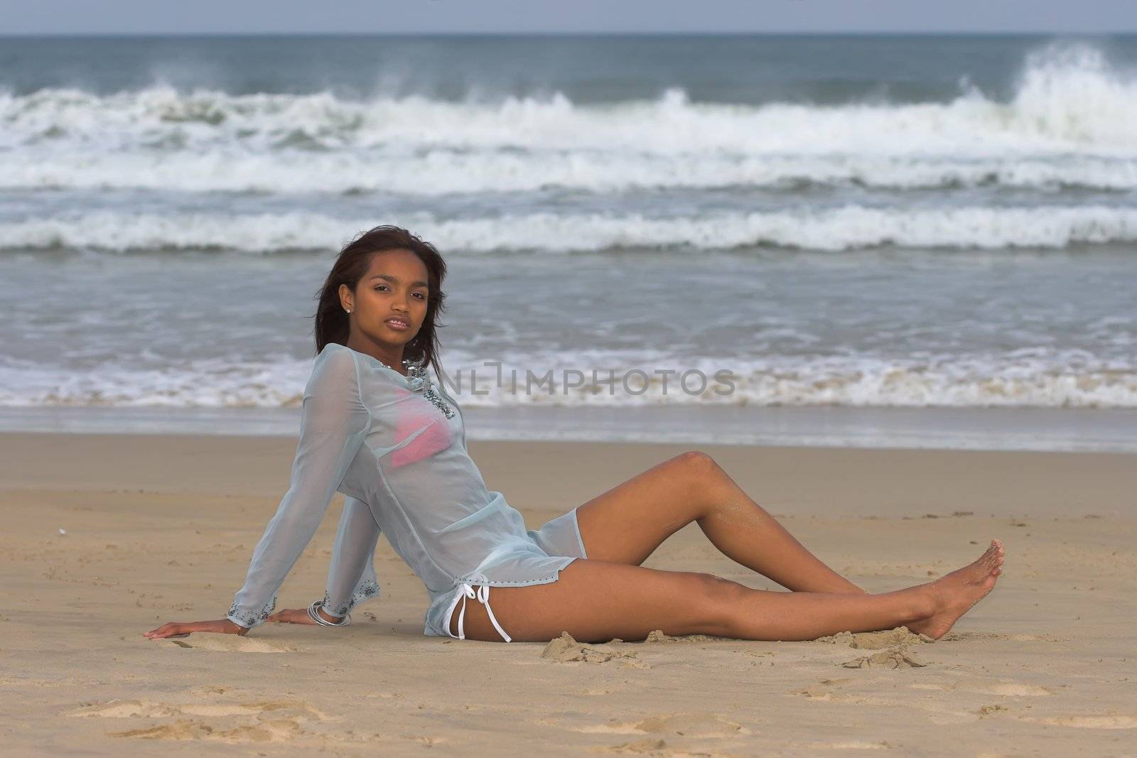 Ethnic bikini model posing at the beach