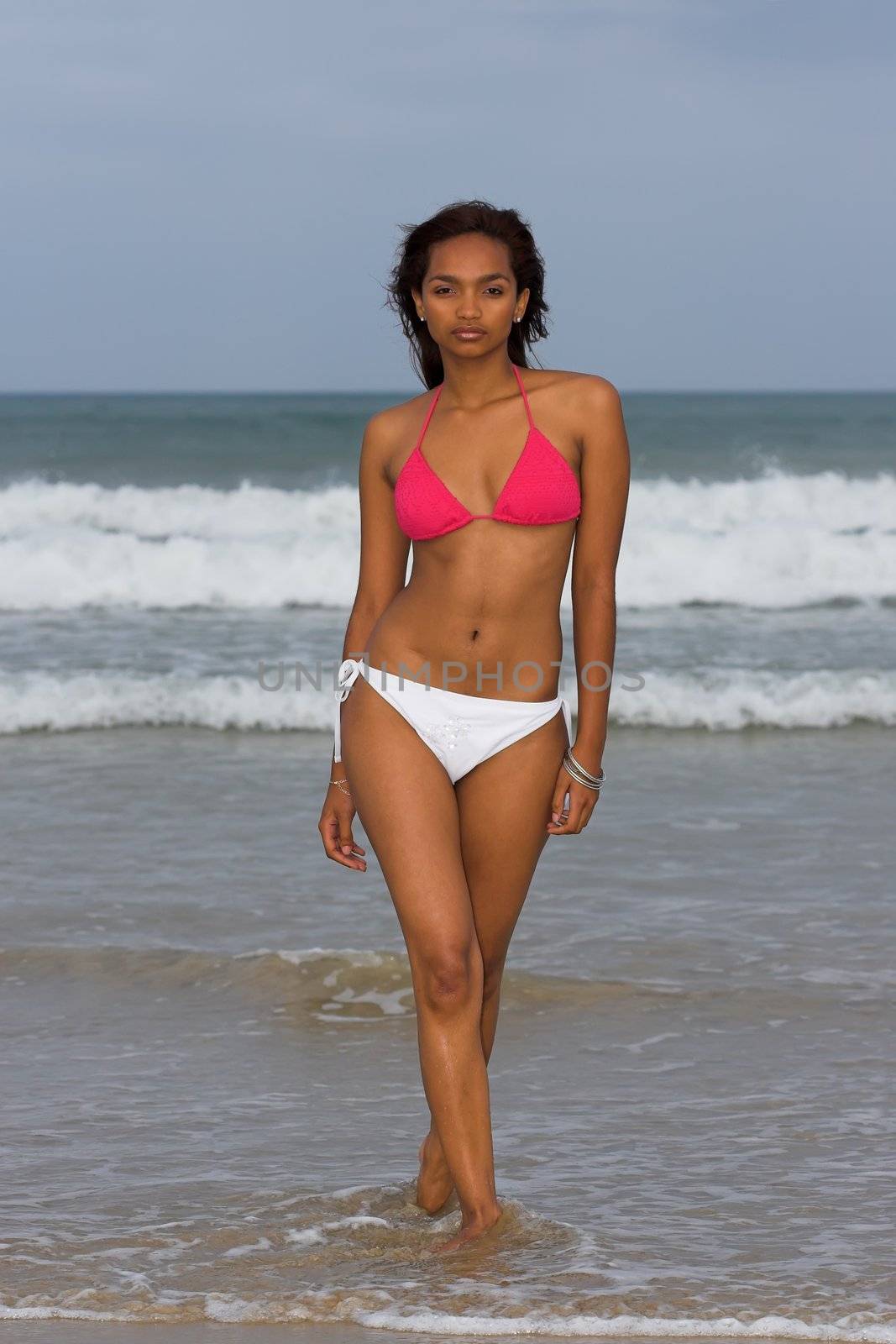 Ethnic Bikini model wearing pink and white bikini