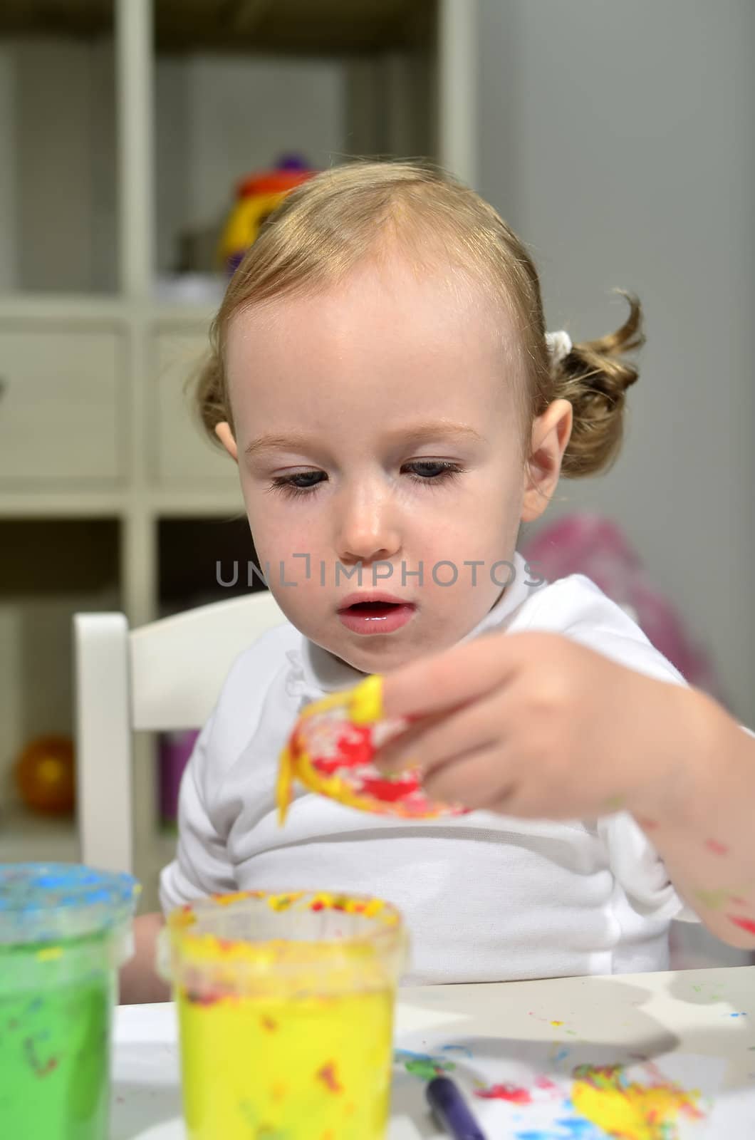 little girl draws with colored inks 