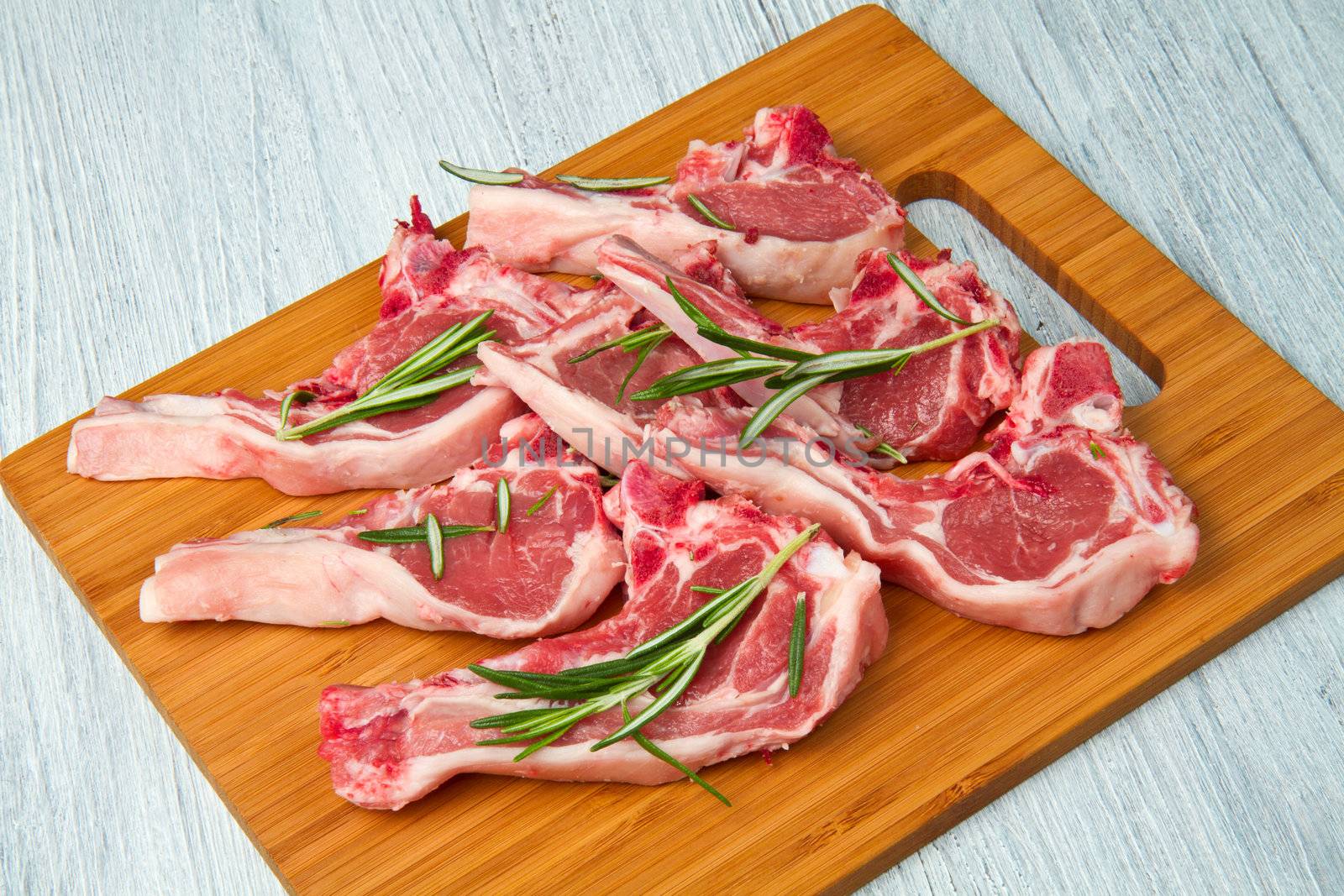 Racks of lamb, ready for cooking, with fresh rosemary