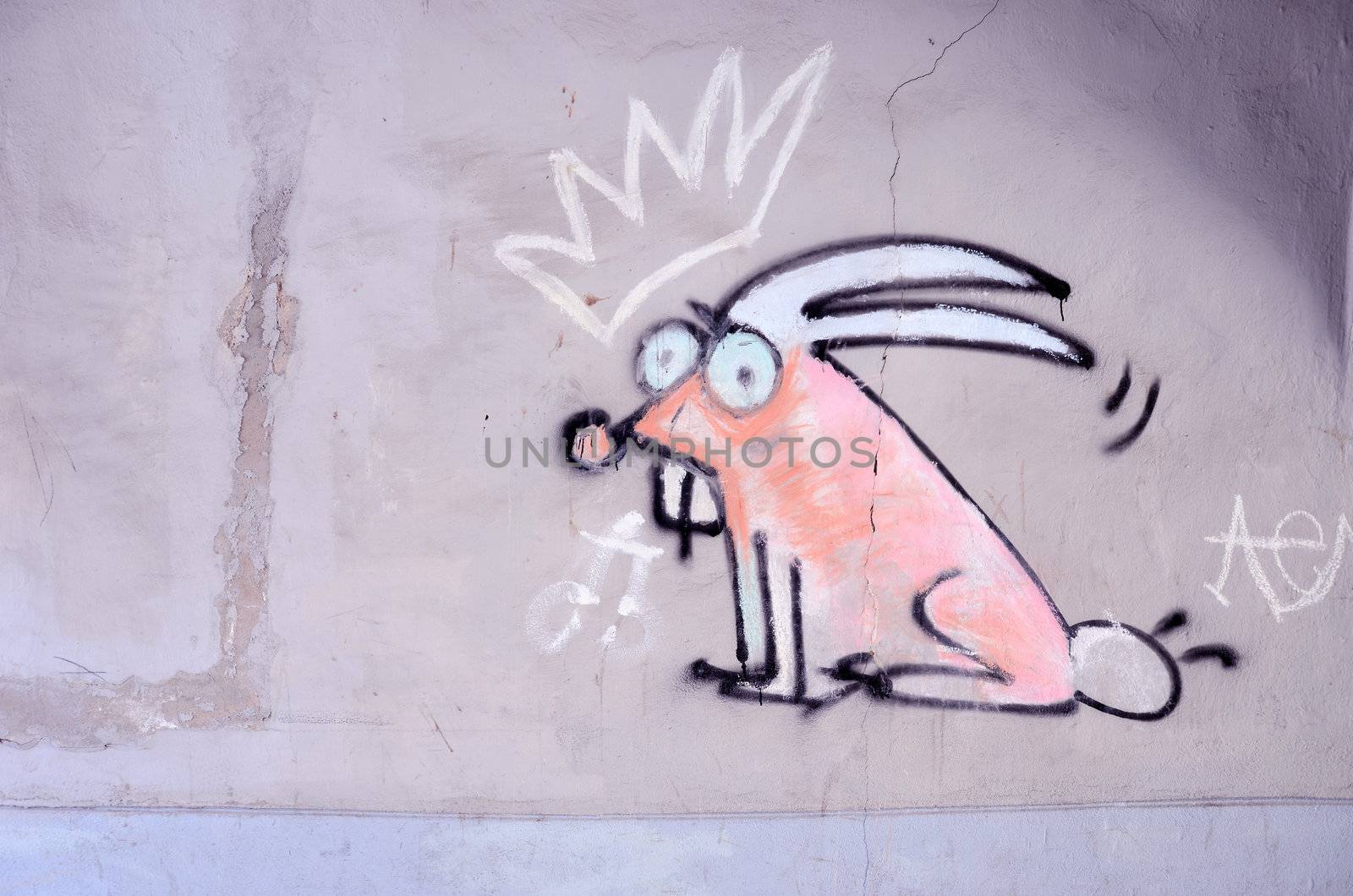 Graffiti on the wall. Crowned bunny with big teeth.