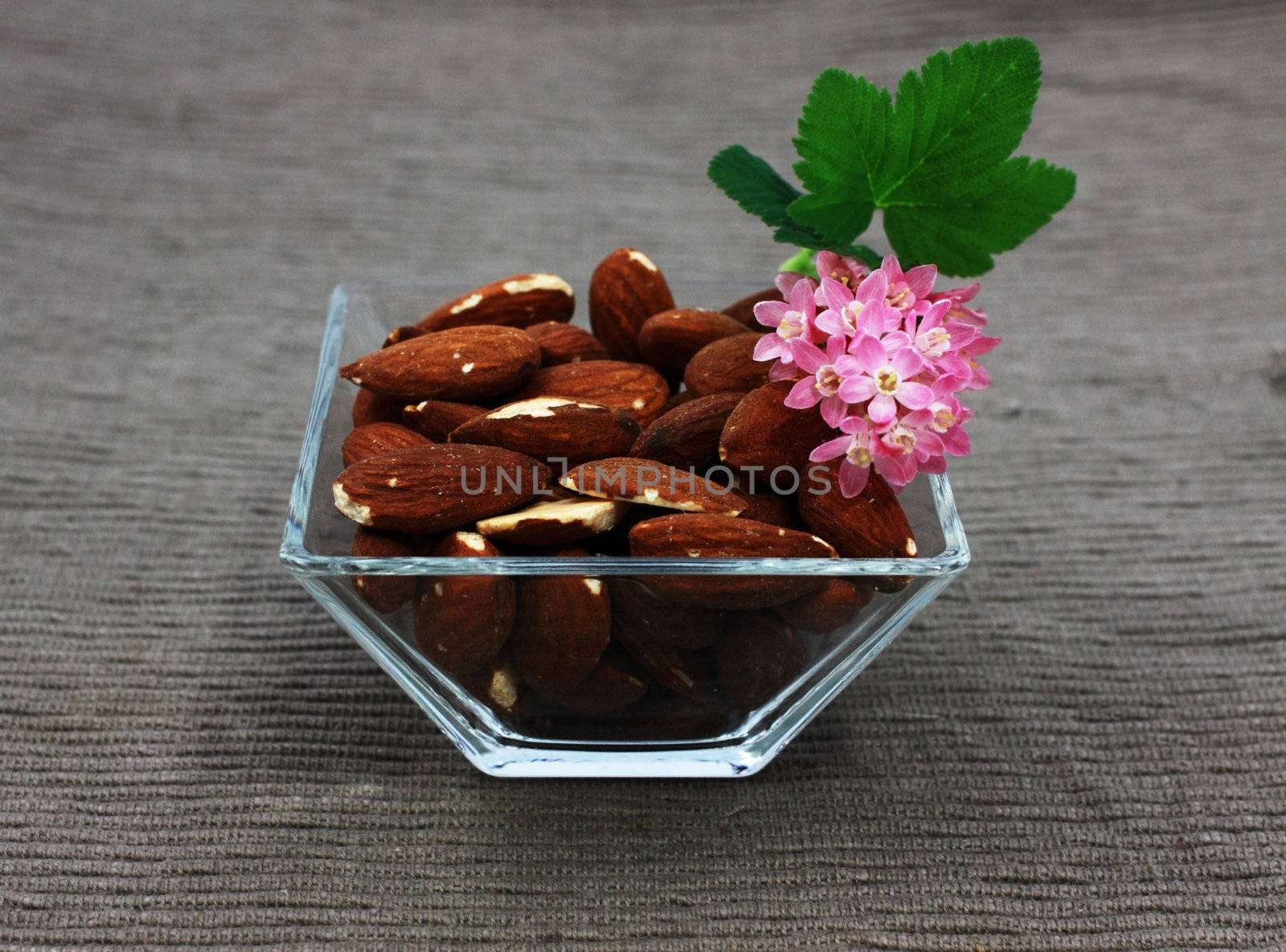 almond and flowers in the glass square bowl
