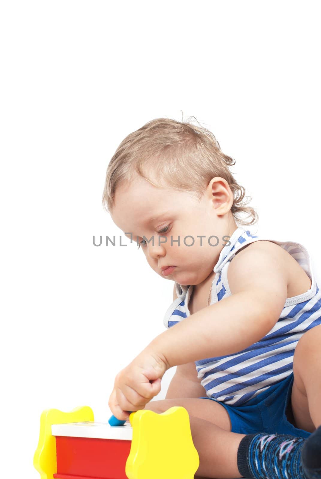 Small baby boy with a toy on white