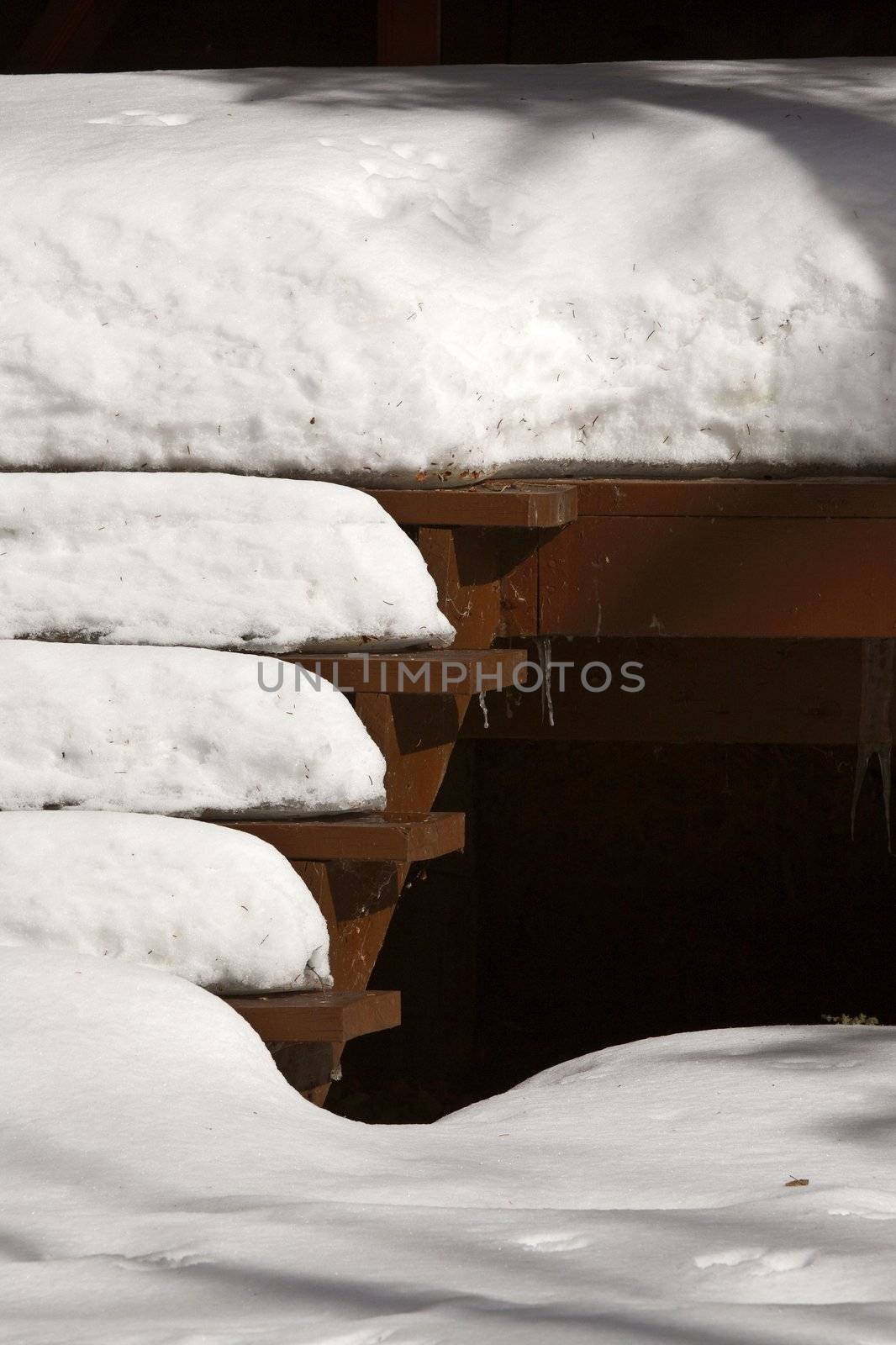 Snow packed on stairs of summer cottage