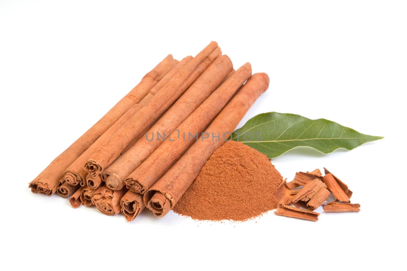 Sticks and powder of cinnamon on white backround