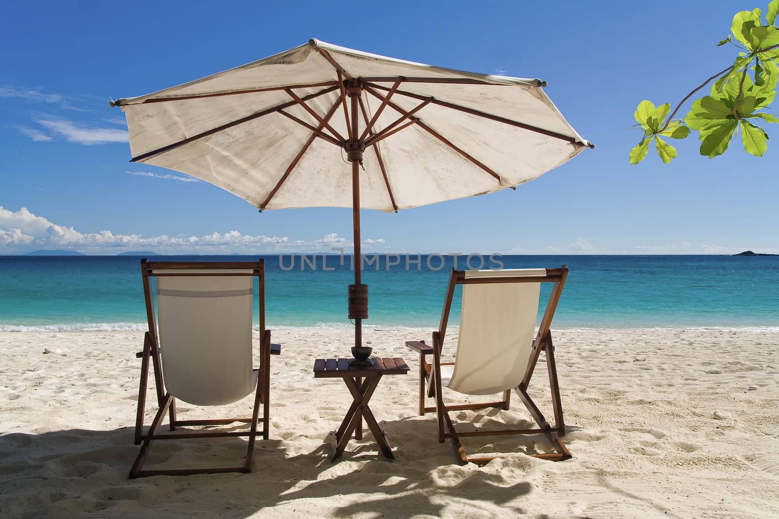 Deckchairs on the beach in front of the lagoon