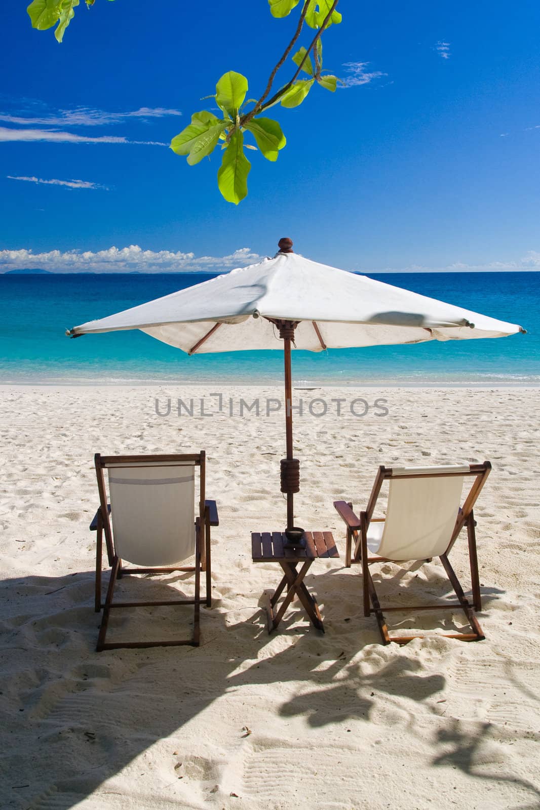 Deckchairs on the beach in front of the lagoon