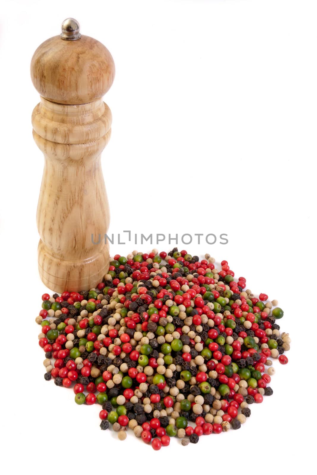 Pepper mill and colorful peppercorns on white background