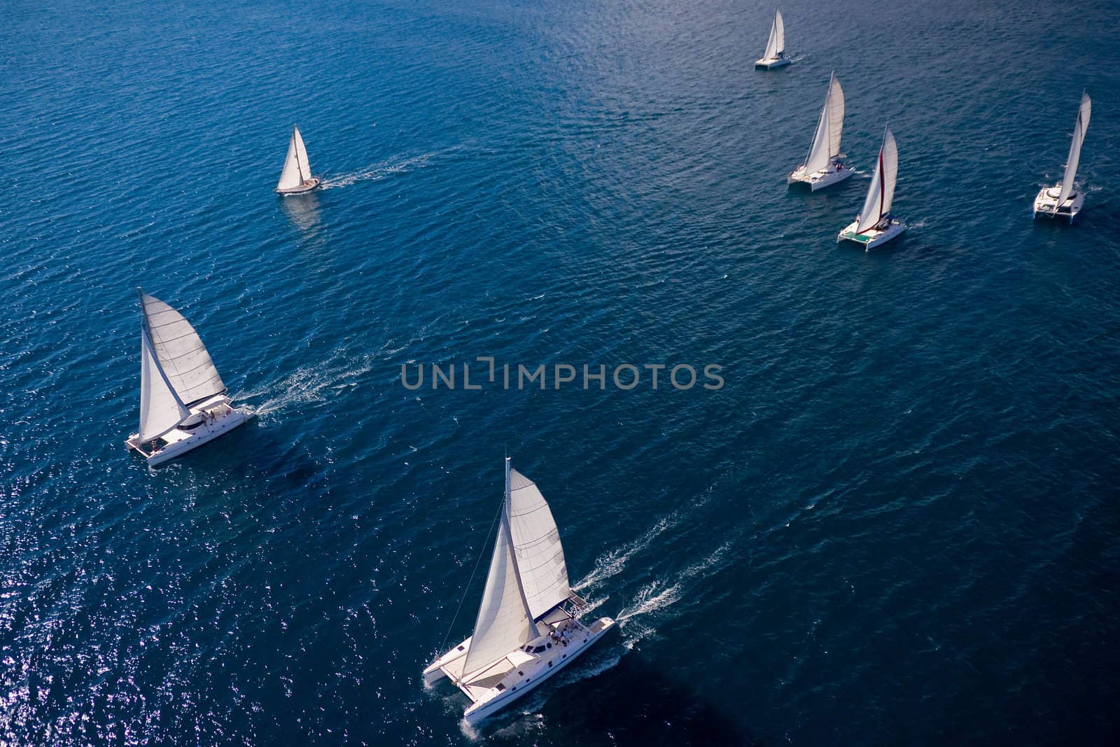 Regatta in indian ocean, sailboat and catamaran. Helicopter view