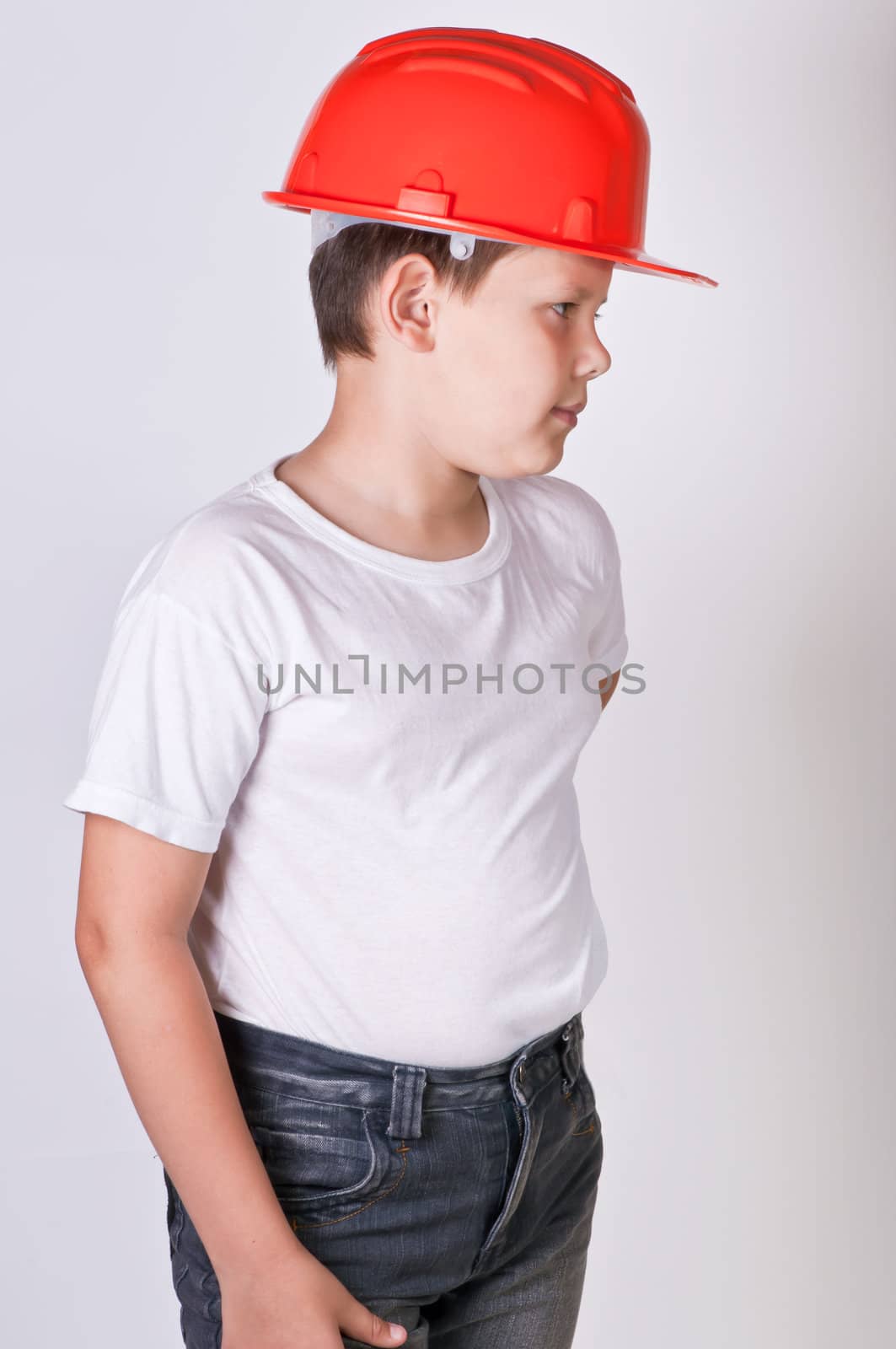 Portrait of a boy in a red protective helmet