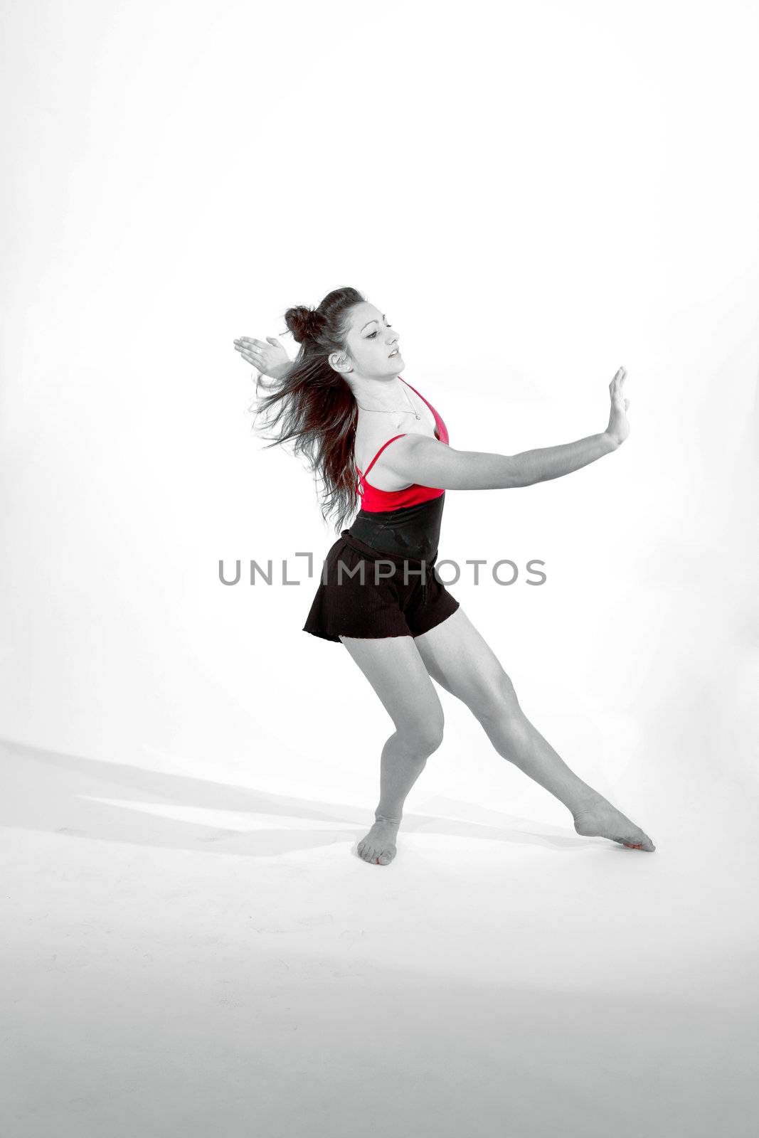Young pretty teenage girl brunette Dancing in studio with long hair