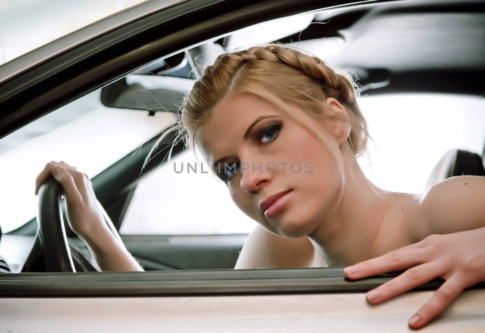  Young woman in the car. by vladimir_sklyarov