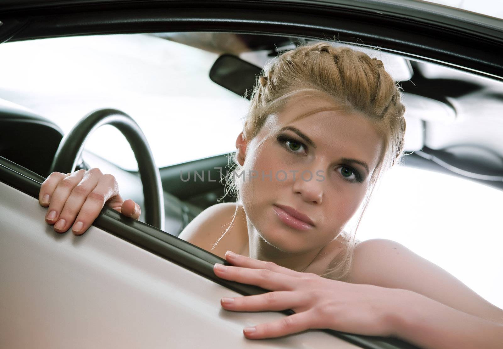  Young woman in the car. by vladimir_sklyarov