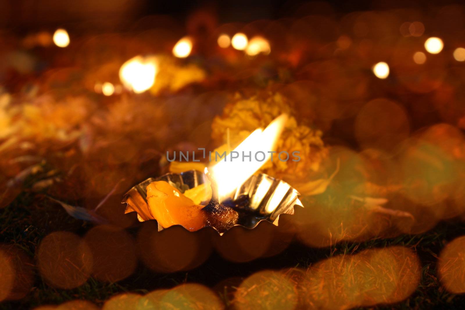 A traditional lamp lit around different lights on the festtive occassion of Diwali festival in India.